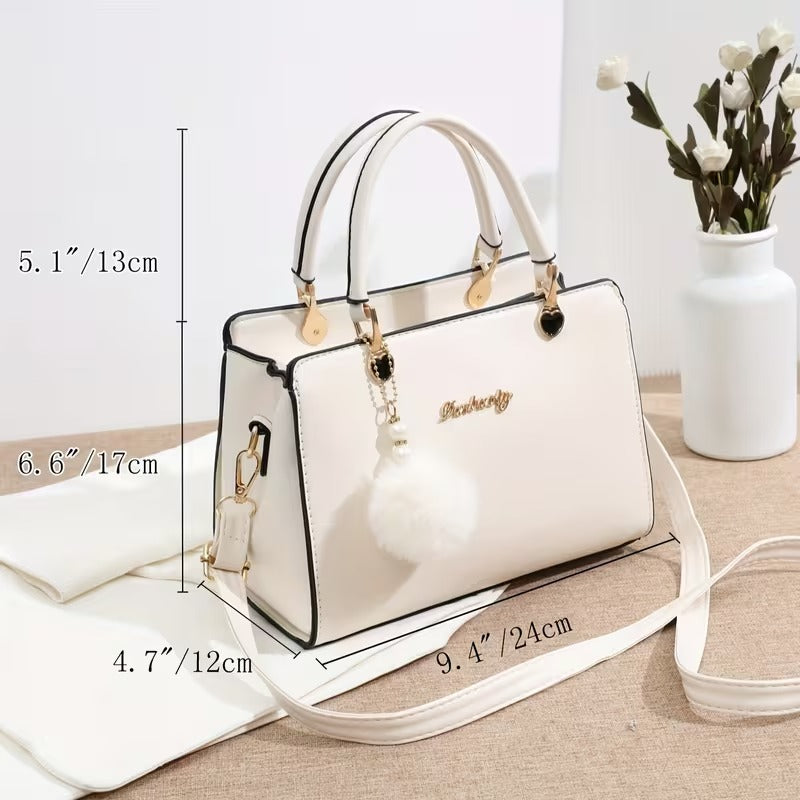 A Stylish Solid Color Handbag with Pom-Pom Decorations (Rs-1995)