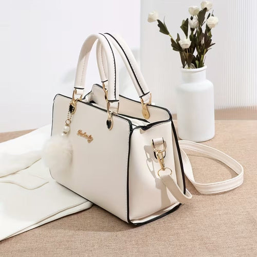 A Stylish Solid Color Handbag with Pom-Pom Decorations (Rs-1995)